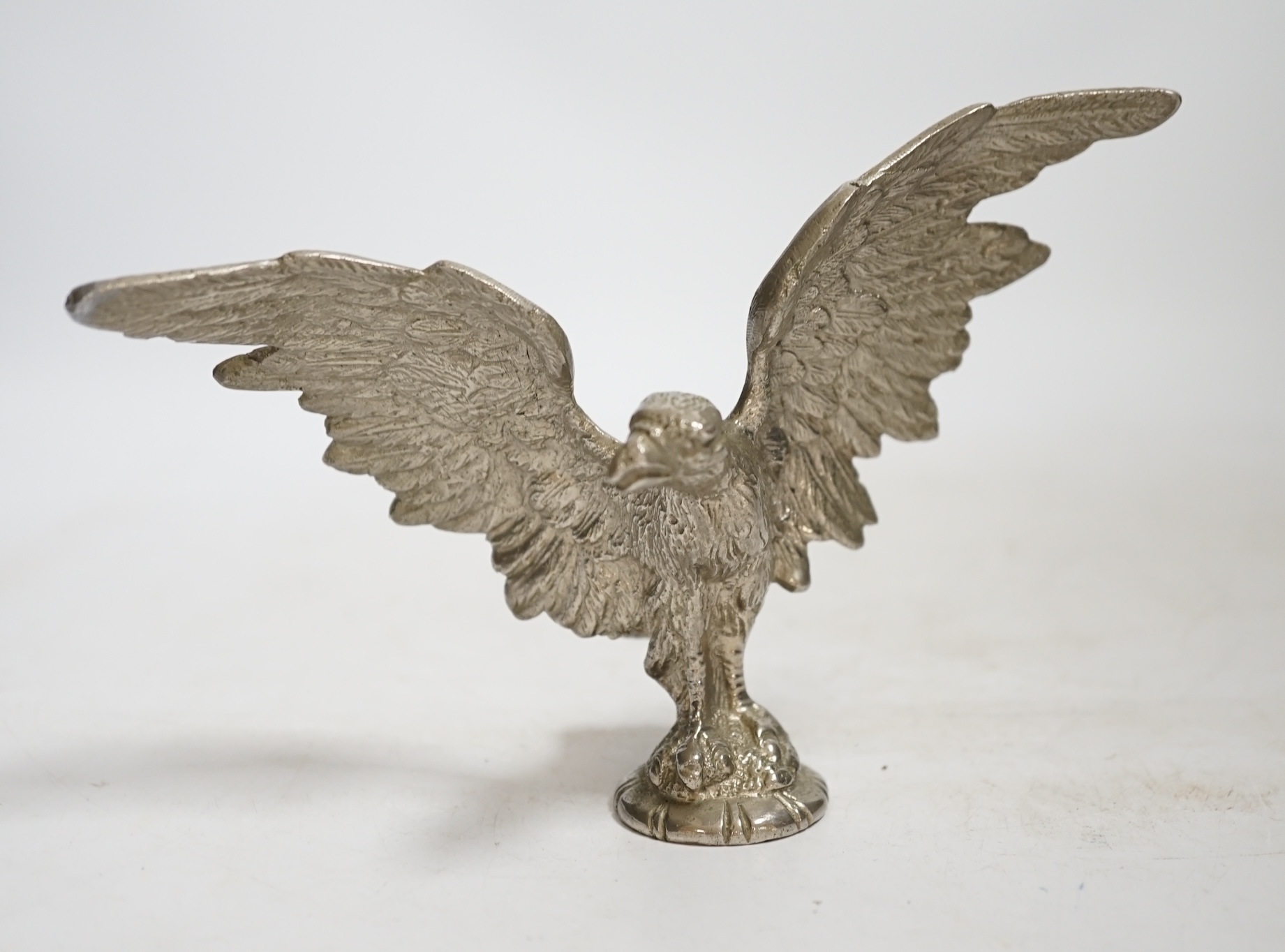 A mid 20th century chromed metal Eagle car mascot, 18cm wide. Condition - fair